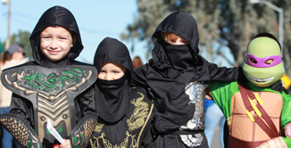 Picture of kids in costumes during halloween parade.