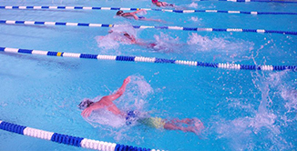 Picture of Jr Gaurds members swimming laps in roped off pool