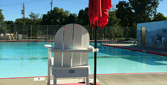 Picture of empty Lifegaurds chair at pool.